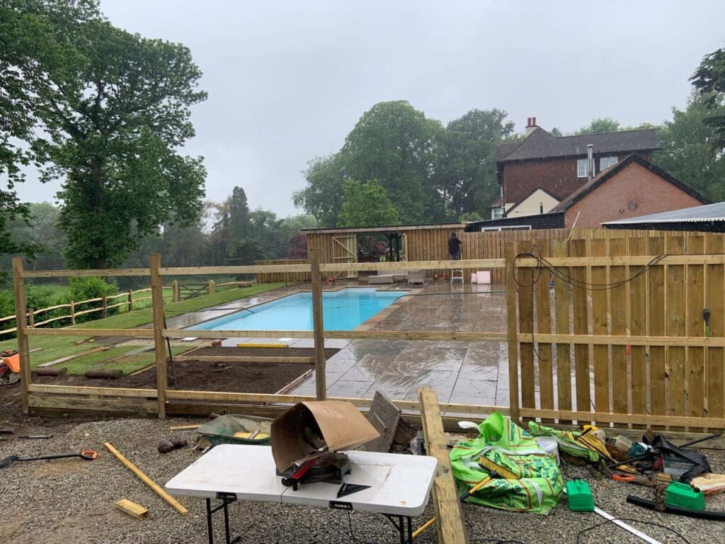 This is a photo of Bespoke custom fencing installed around a swimming pool by Fast Fix Fencing Rochester